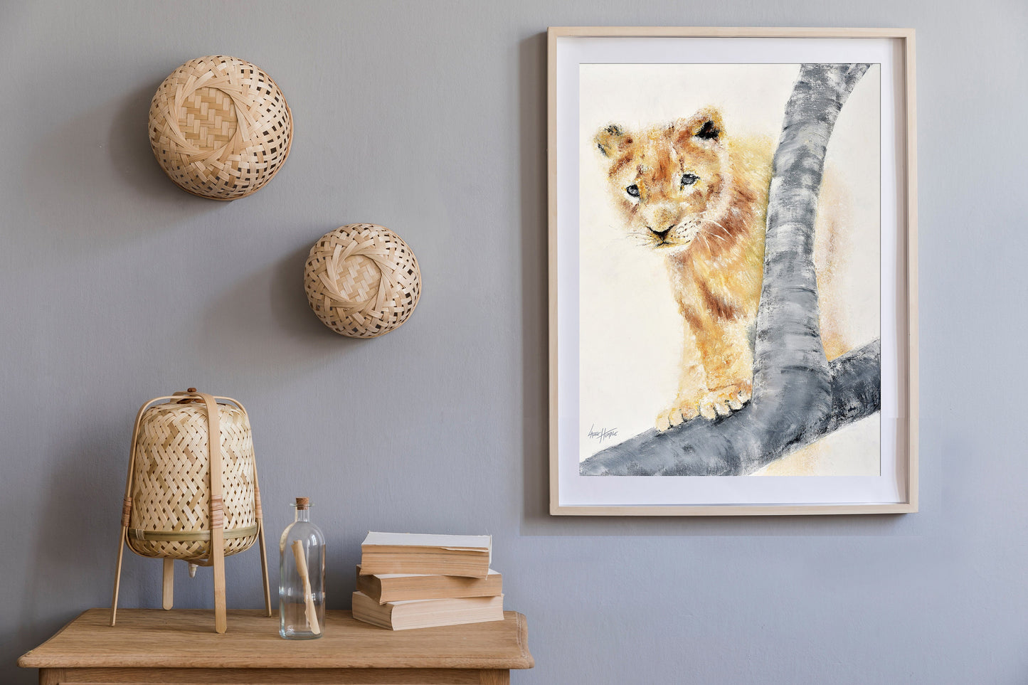 Printable lion cub art for nursery or safari-themed decor shown on a wall