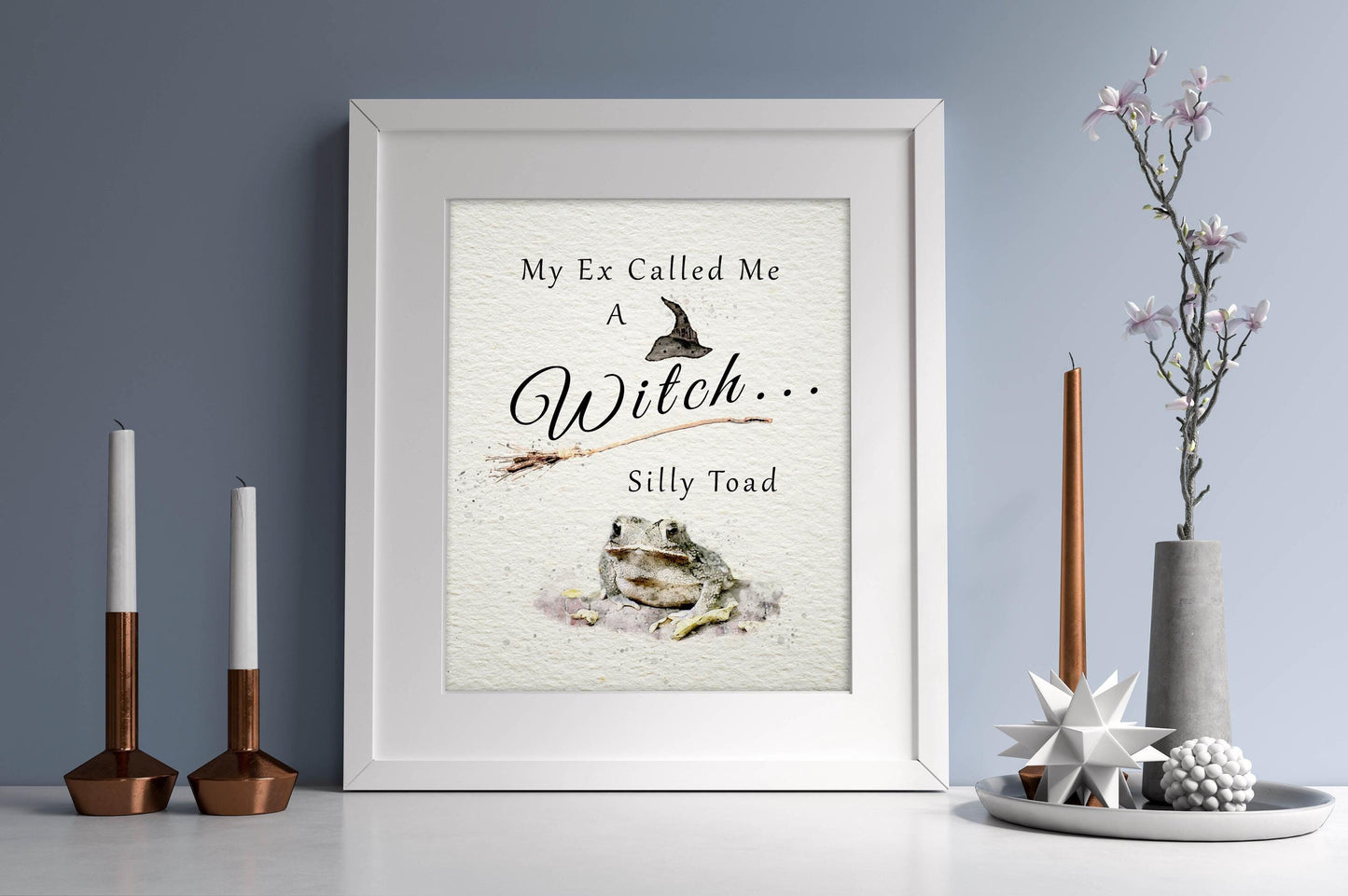 Digital witch-themed decor with the quote, "My Ex Calls Me A Witch, Silly Toad."